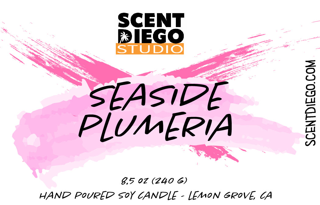 A label for Seaside Plumeria candle by Scent Diego Studio, featuring the product name and the scent of the candle, with a pink and white color scheme.