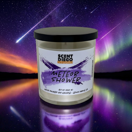 Candle jar labeled 'Meteor Shower' by Scented Diego Studio against a cosmic background with meteors.
