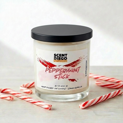 Scented candle labeled 'Peppermint Stick' by Scented Diego with candy canes on a light background