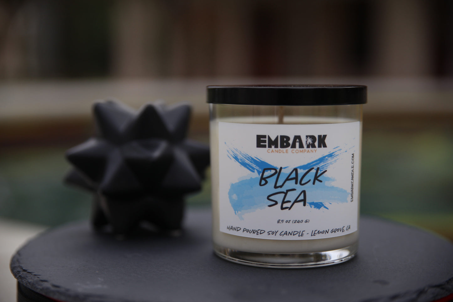 Black Sea hand poured soy candle with lid on ledge